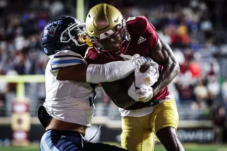 The Maine defense tries to tackle Zay Flowers during Boston College vs Maine at Alumni Stadium.