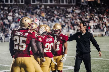 Coach Jeff Hafley greets his team on the sideline during Boston College vs Maine at Alumni Stadium.