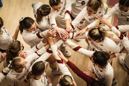 BC Volleyball huddles after tough five set win against Bryant