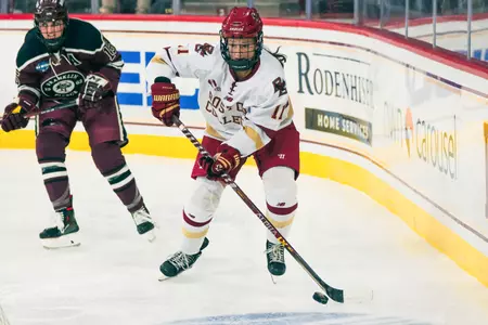 Katie Pyne skates the puck behind the net.