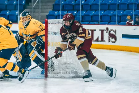 Abby Newhook circles behind the net at Quinnipiac.