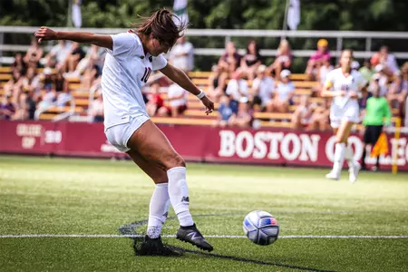Emily Sapienza kicks the ball, shooting on net against Holy Cross.