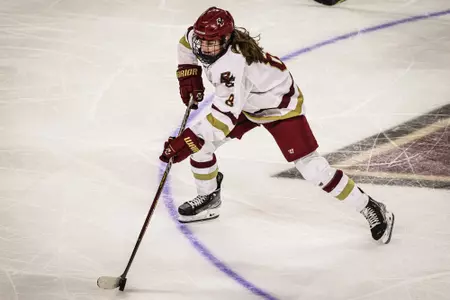 Kara Goulding skates across center ice with the puck.
