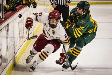 Connor Joyce fights for the puck against UVM