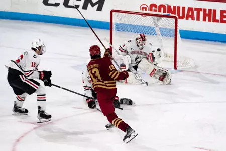 Nikita Nesterenko shoots the puck at Northeastern