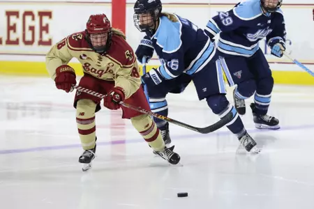Kelly Browne skates with the puck against Maine.