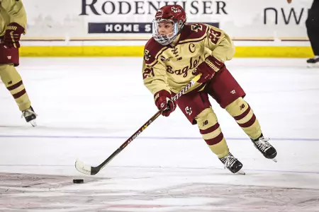 Cayla Barnes skates the puck up the middle of the ice.