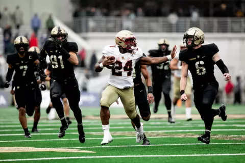 Pat Garwo stiff-arms a tackler at Army.