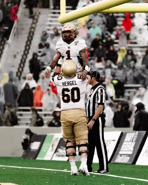 Kyle Hergel hoists Castellanos into the air after a touchdown at Army.