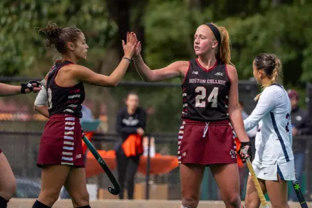 Margo Carlin and Kendall Hanlon high-five during game vs. UConn