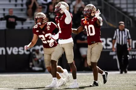 Defensive backs celebrate an interception at Georgia Tech