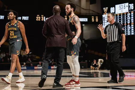 Head coach Earl Grant talks with Jaeden Zackery in the closing minutes of the Vanderbilt game
