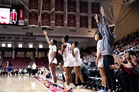 The team celebrating on the bench against Stonehill