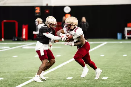 Thomas Castellanos handing off to Kye Robichaux