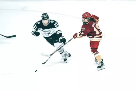 Hannah Bilka shoots the puck at Providence.