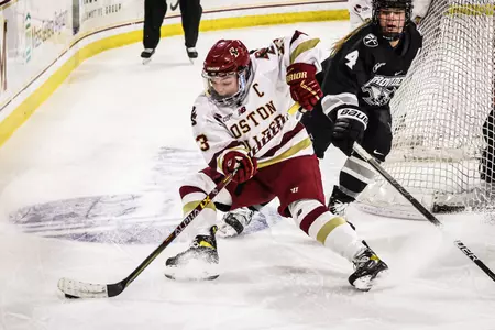 Cayla Barnes turns with the puck behind the net.