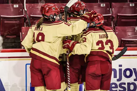 Hannah Bilka (left) and Cayla Barnes (right) celebrate a goal.