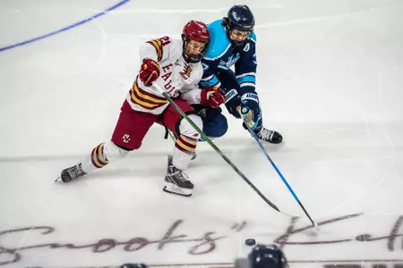 Oskar Jellvik challenges for the puck against Maine