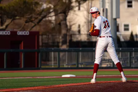 Sean Hard looks over his shoulder to first base from the mound vs. Sacred Heart