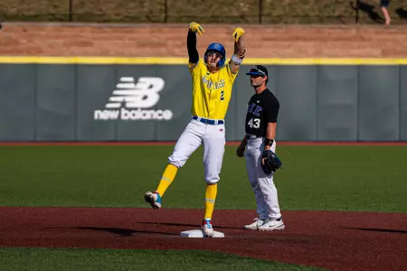 Travis Honeyman flashes his double celebration to the dugout, while standing on second, against Duke.