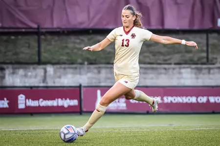Claire Mensi kicks the ball up the field.
