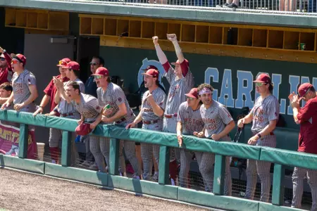 BC players celebrate and cheer in the first base dugout at UNC.