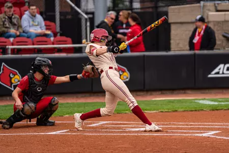 Abi Knight swings during at bat against Louisville