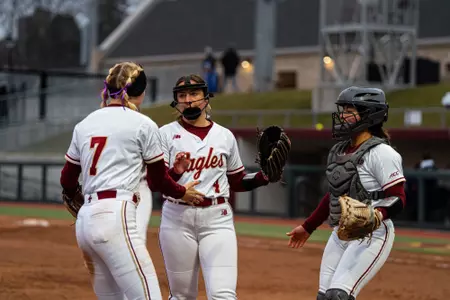 Abby Dunning, Maddy Carpe and Abi Knight celebrate after win against Merrimack