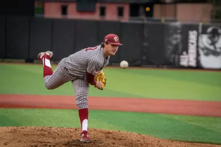 Henry Leake pitches.