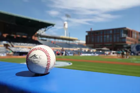 A baseball rests on the dugout rail at the Durham Bulls Athletic Park.