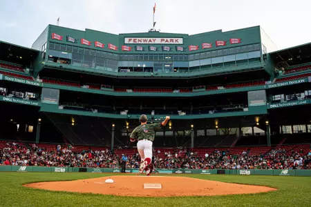 John West (photographed from behind) takes his warmup pitches at Fenway Park with three grandstand and press box seen in background of the photo.