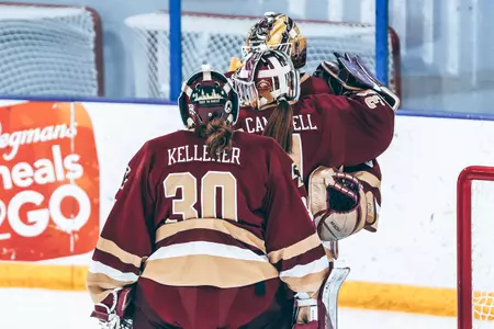 Janelle Kelleher, Grace Campbell and Abbey Levy hug after a game.