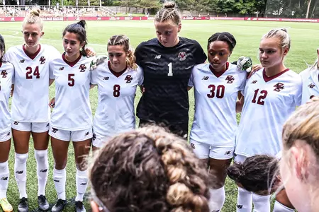 BC women's soccer huddles before a game.