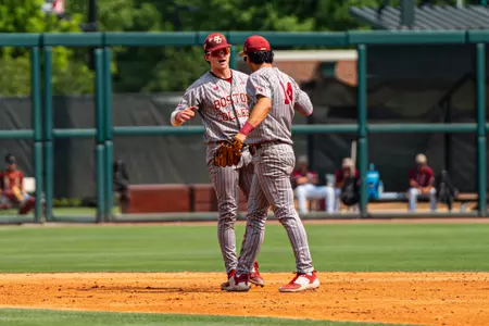 Sam McNulty and Vince Cimini high-five after turning a double play vs. Troy.
