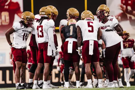 Thomas Castellanos calls a play in the huddle