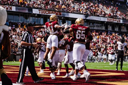 Lewis Bond celebrates touchdown reception with teammates in the endzone