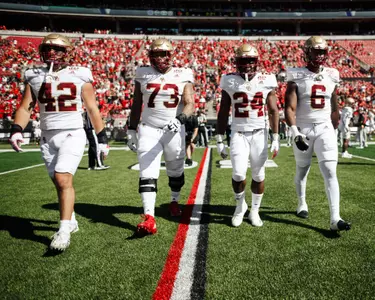 Captains walk to midfield at Louisville.