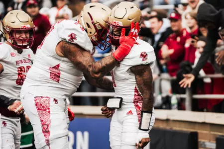 Thomas Castellanos is congratulated in the end zone by Christian Mahogany