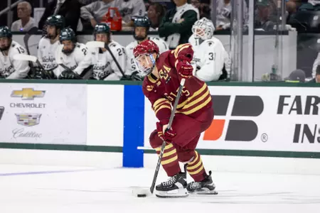 Ryan Leonard skates with puck against Michigan State