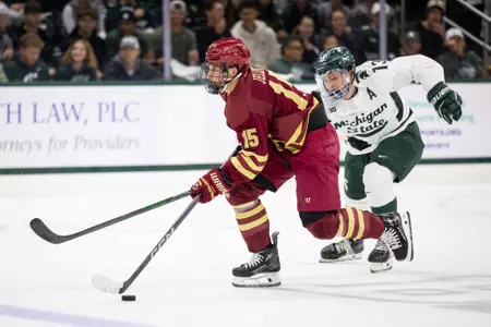 Oskar Jellvik skating with puck against Michigan State