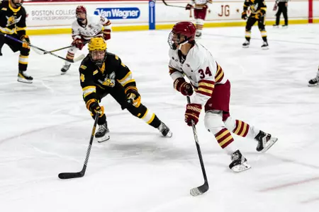 Gabe Perreault skating with puck against AIC