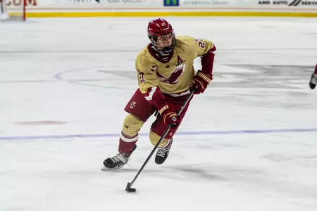 Connor Joyce skating with puck against Maine