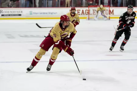 Dean Letourneau skating with puck against Northeastern