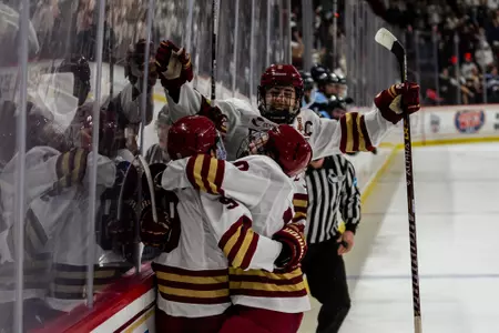 Men's Hockey celebrating win over Maine