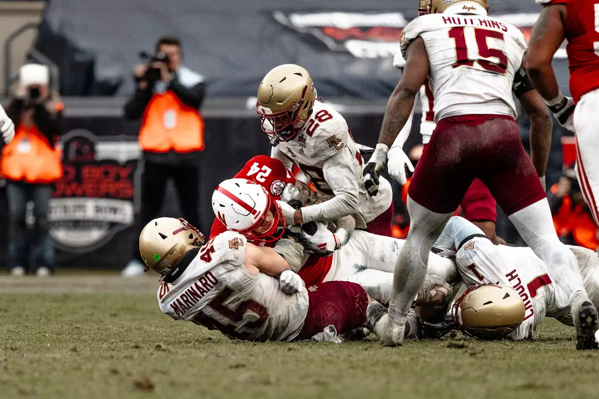 Joe Marinaro and Carter Davis make a tackle.