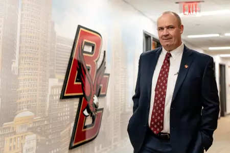 Bill O'Brien walks down the hallway inside the Yawkey Athletic Center.