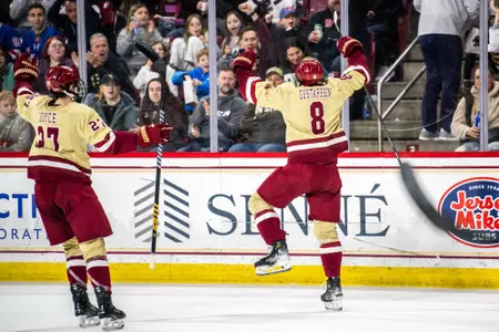 Lukas Gustafsson raises his arms in celebration after scoring.