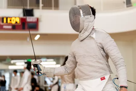 Fencing competing at home meet
