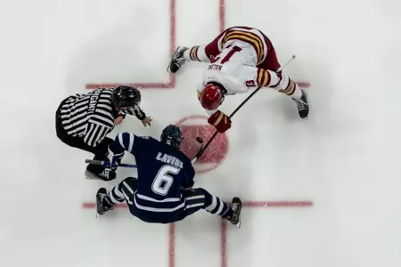 Jack Malone takes a faceoff vs. UNH.