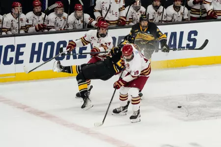 Two BC players sandwich a MTU player.